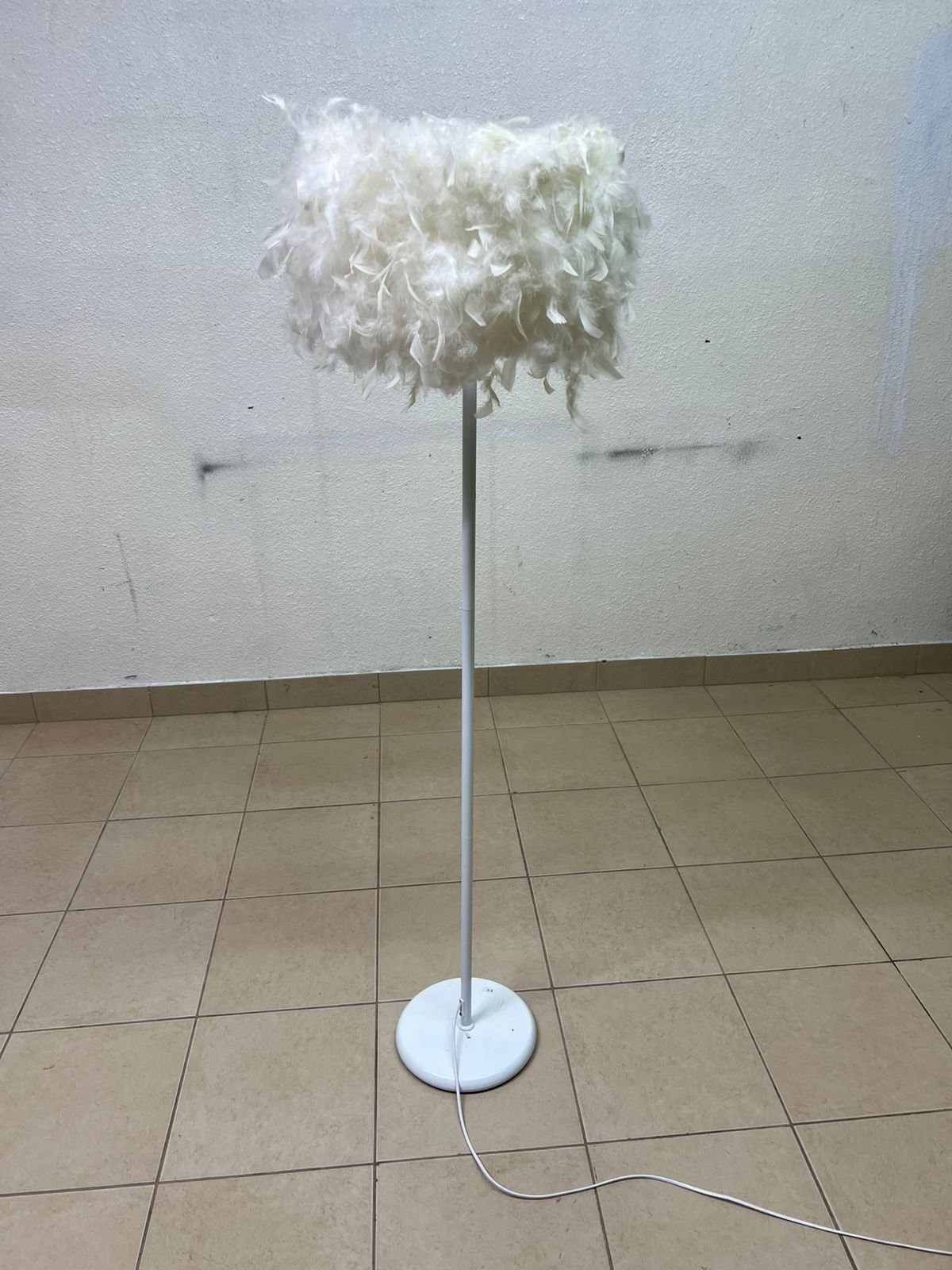 A modern floor lamp featuring a stylish cylindrical shade made of soft white feathers with a white metal base and pole. - Image 6