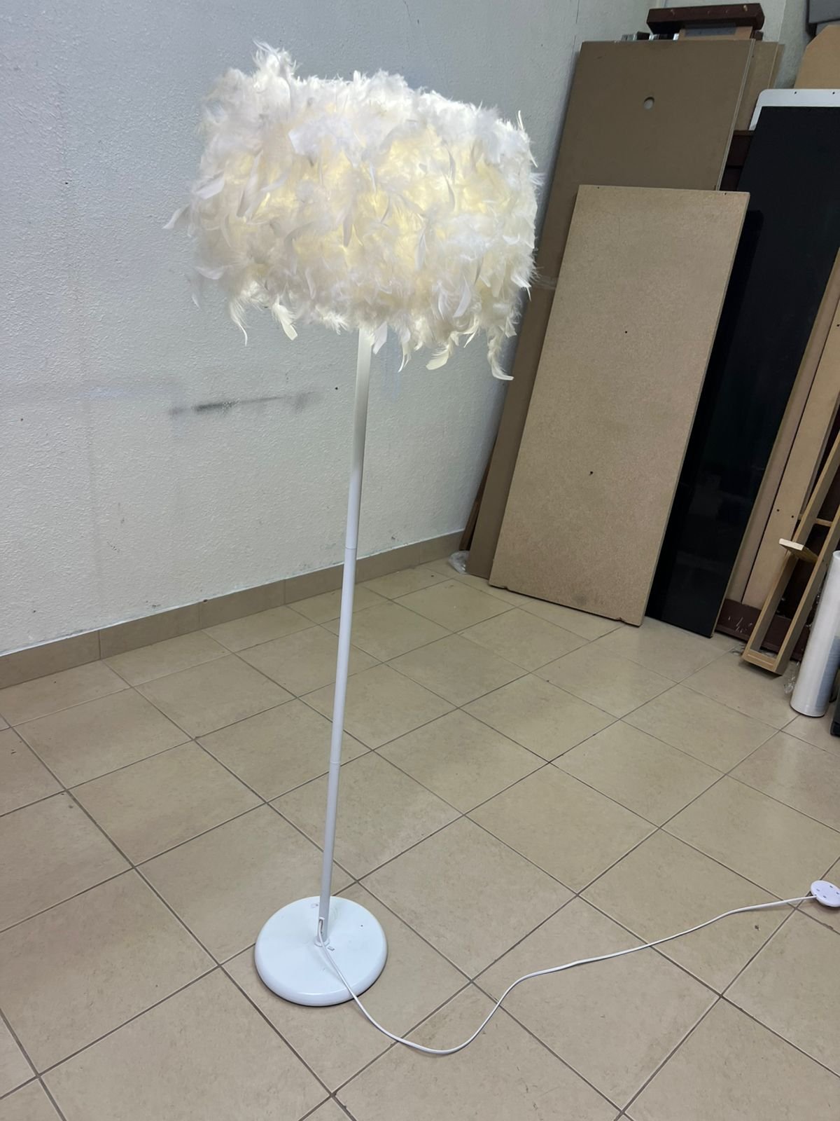 A modern floor lamp featuring a stylish cylindrical shade made of soft white feathers with a white metal base and pole. - Image 7