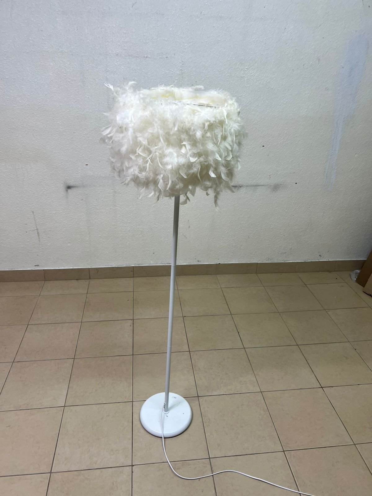 A modern floor lamp featuring a stylish cylindrical shade made of soft white feathers with a white metal base and pole. - Image 8