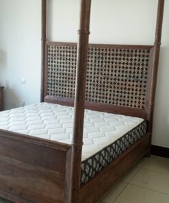 A bed, a piece of wooden furniture with a four-poster design and a headboard decorated with raised geometric patterns, along with a mattress. - Image 3