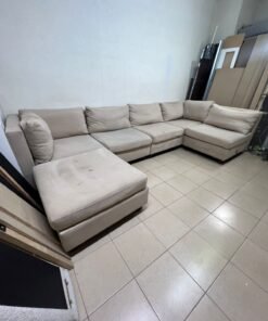 A spacious, modern, U-shaped sectional sofa in a calm beige color with a footrest. - Image 4