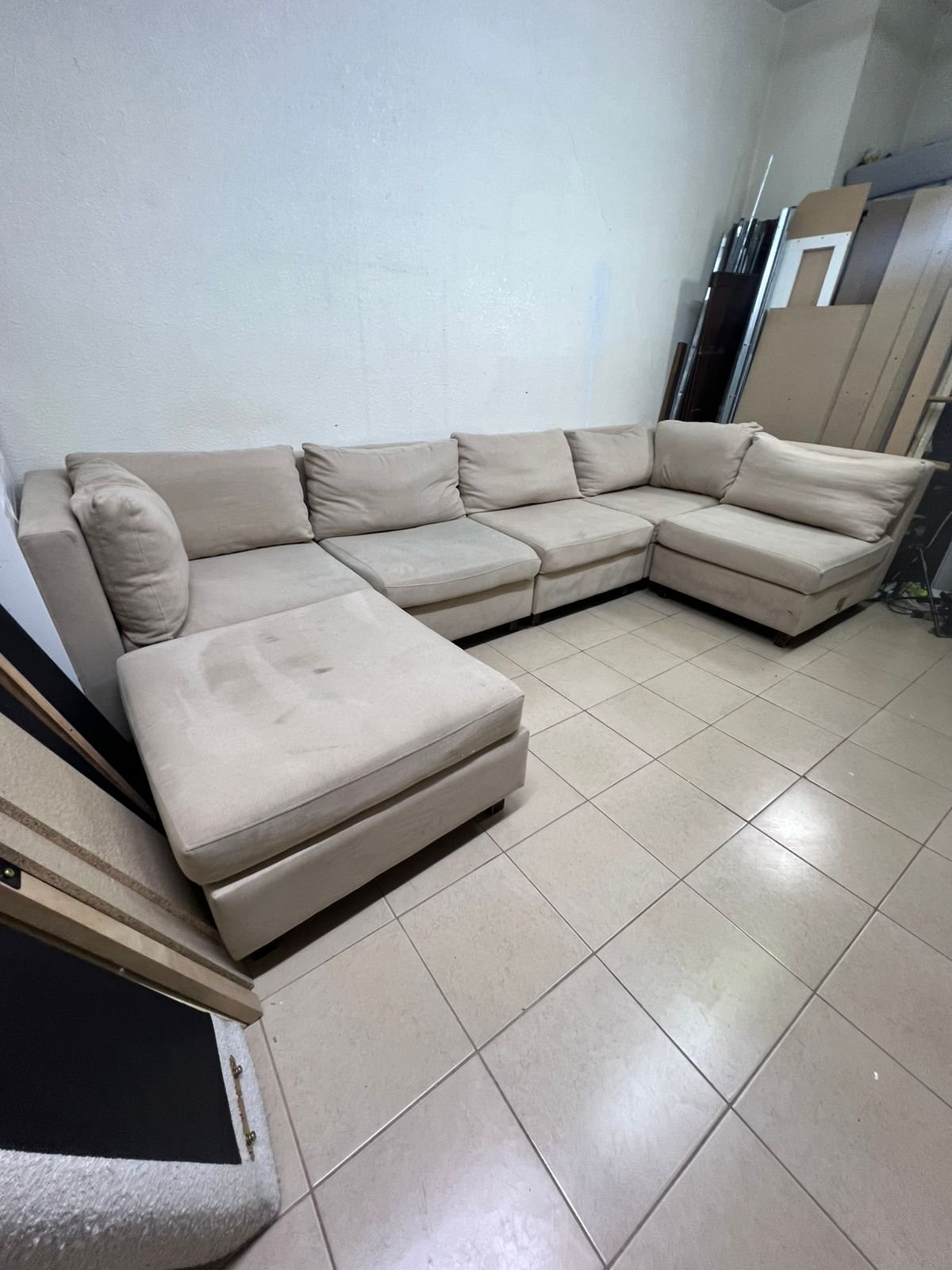 A spacious, modern, U-shaped sectional sofa in a calm beige color with a footrest. - Image 4