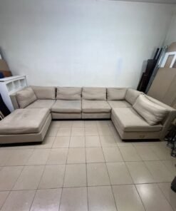 A spacious, modern, U-shaped sectional sofa in a calm beige color with a footrest. - Image 5