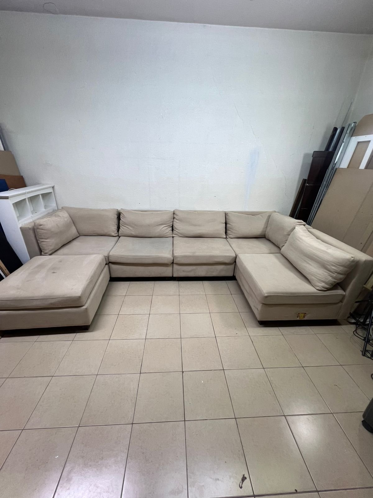 A spacious, modern, U-shaped sectional sofa in a calm beige color with a footrest. - Image 5