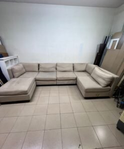 A spacious, modern, U-shaped sectional sofa in a calm beige color with a footrest. - Image 6