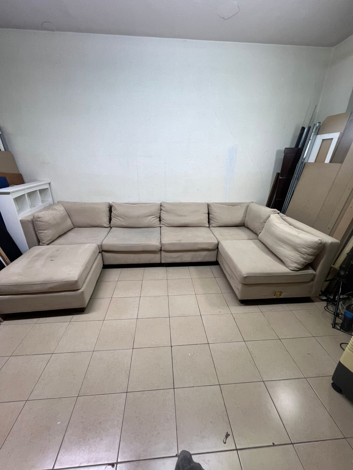 A spacious, modern, U-shaped sectional sofa in a calm beige color with a footrest. - Image 6