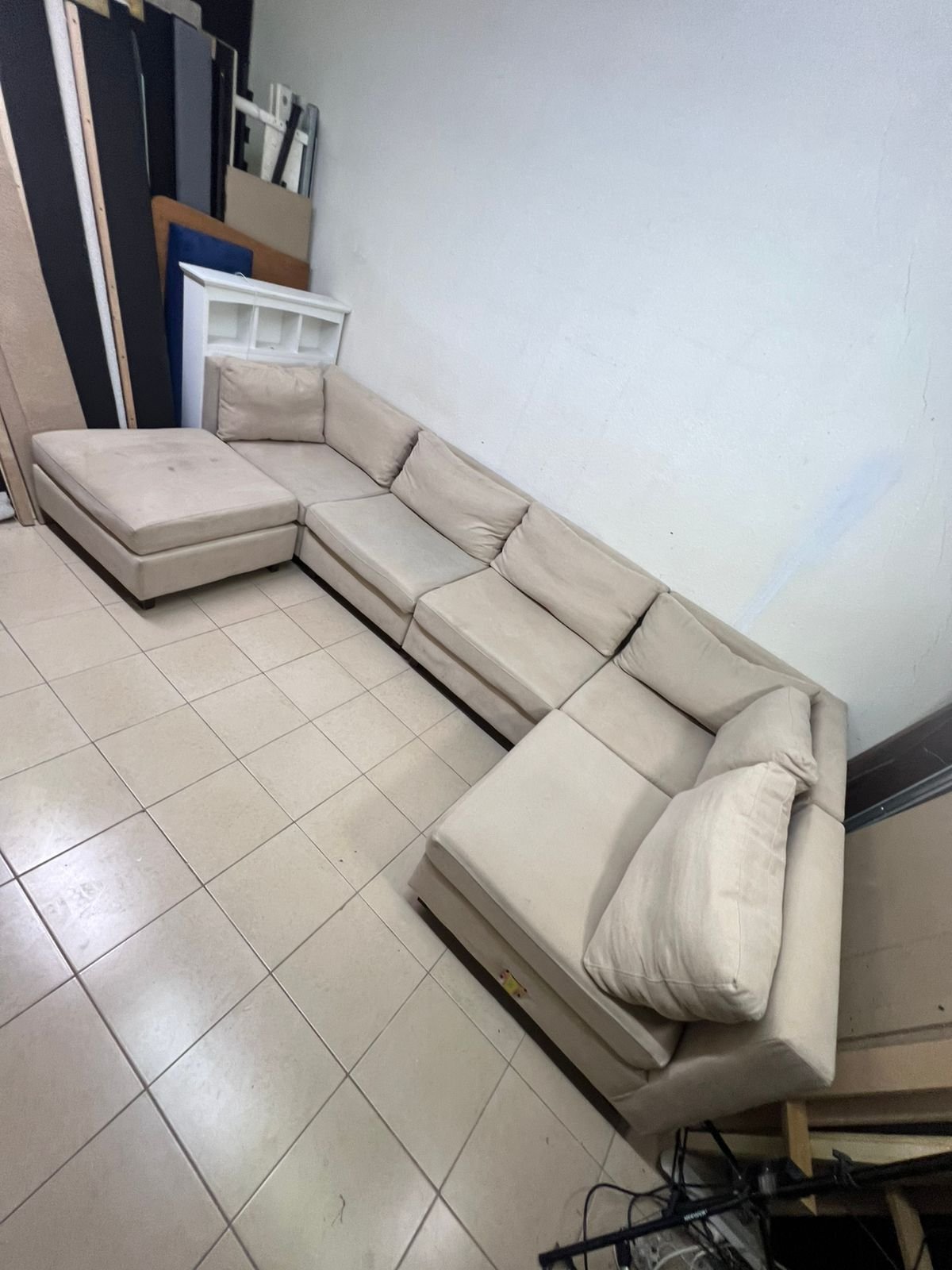 A spacious, modern, U-shaped sectional sofa in a calm beige color with a footrest. - Image 8