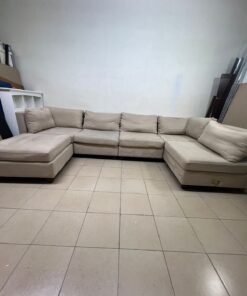A spacious, modern, U-shaped sectional sofa in a calm beige color with a footrest. - Image 2