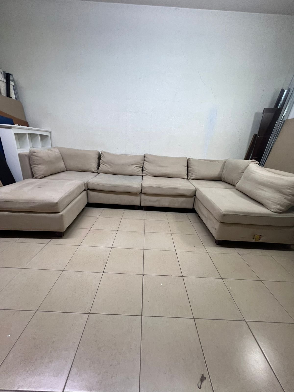 A spacious, modern, U-shaped sectional sofa in a calm beige color with a footrest. - Image 2