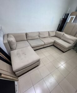 A spacious, modern, U-shaped sectional sofa in a calm beige color with a footrest. - Image 3