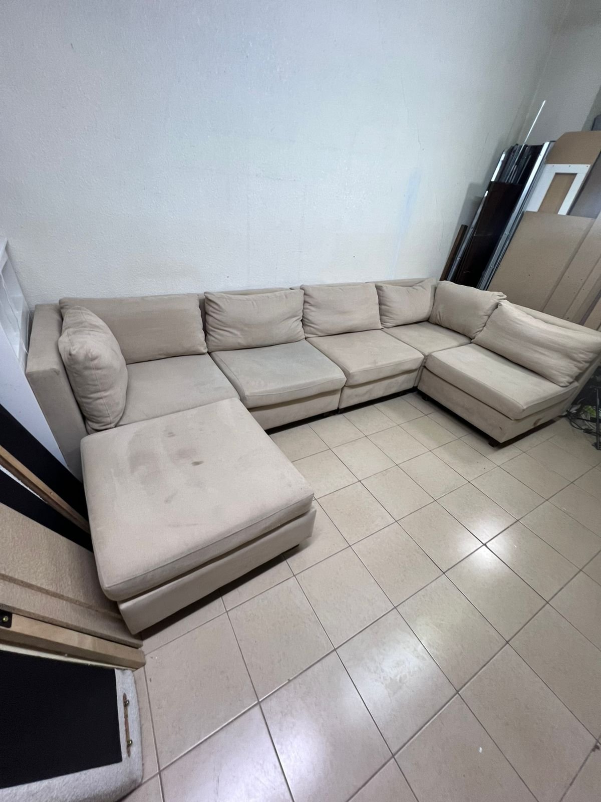 A spacious, modern, U-shaped sectional sofa in a calm beige color with a footrest. - Image 3