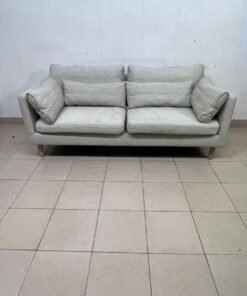 A spacious light beige fabric sofa with back cushions and additional long, square cushions. - Image 3