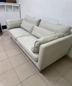 A spacious light beige fabric sofa with back cushions and additional long, square cushions. - Image 4