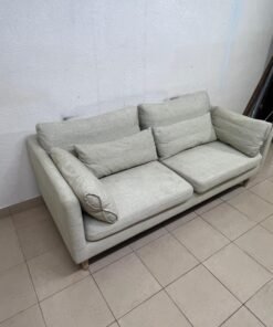 A spacious light beige fabric sofa with back cushions and additional long, square cushions. - Image 6