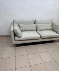 A spacious light beige fabric sofa with back cushions and additional long, square cushions. - Image 8