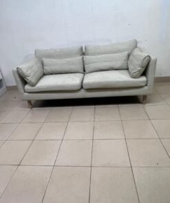 A spacious light beige fabric sofa with back cushions and additional long, square cushions. - Image 9