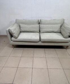 A spacious light beige fabric sofa with back cushions and additional long, square cushions. - Image 2