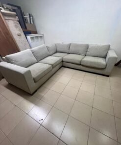 A corner sofa with a modern design (L-shaped) and upholstered in light beige or calm gray fabric. - Image 9