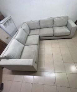 A corner sofa with a modern design (L-shaped) and upholstered in light beige or calm gray fabric. - Image 6