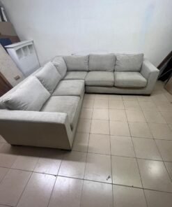 A corner sofa with a modern design (L-shaped) and upholstered in light beige or calm gray fabric. - Image 5