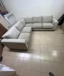 A corner sofa with a modern design (L-shaped) and upholstered in light beige or calm gray fabric. - Image 3