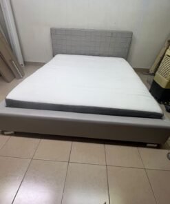 Grey double bed frame with upholstered design and distinctive headboard. - Image 2