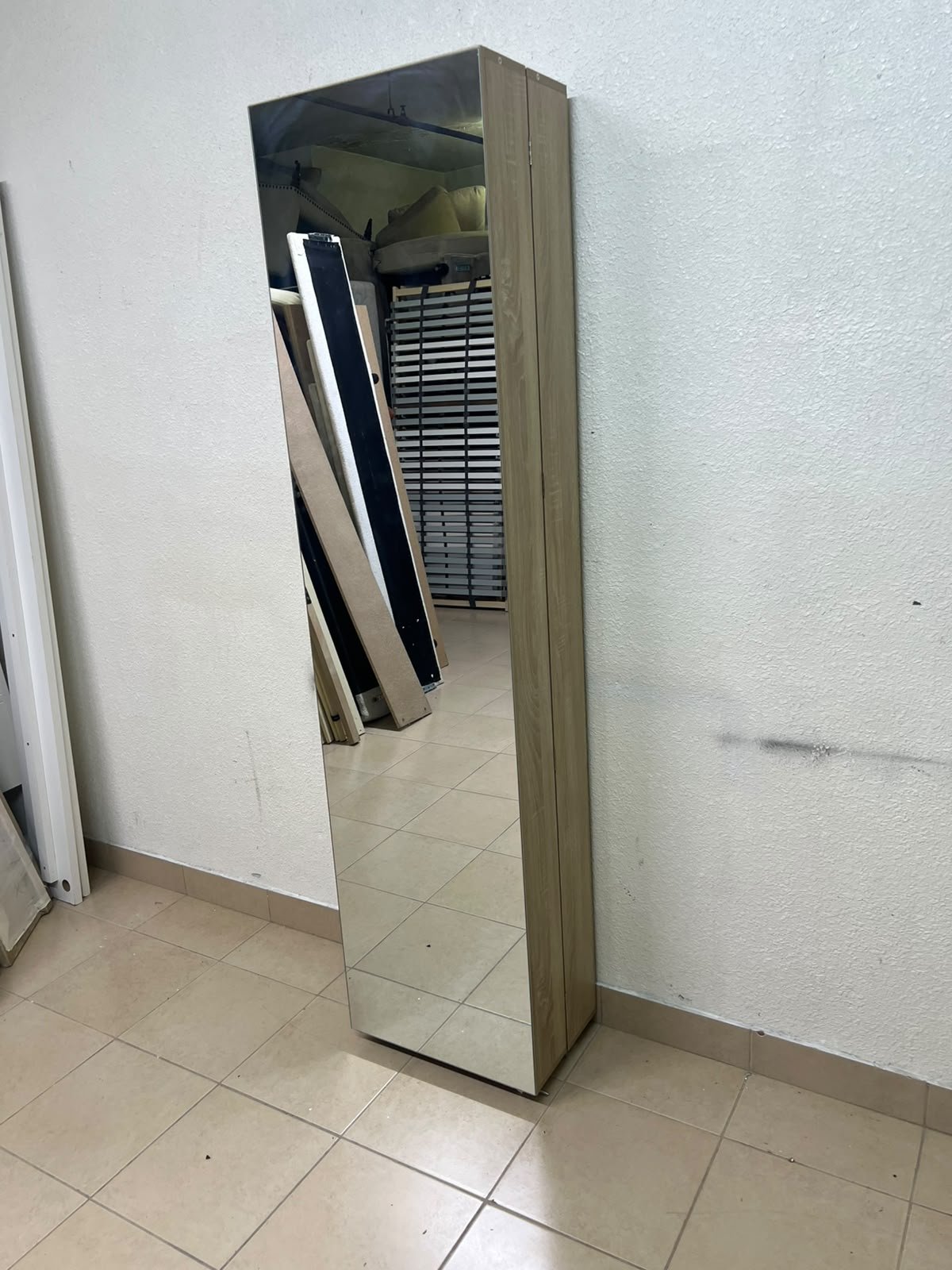 A slim shoe cabinet or wardrobe with a single door and a full-length mirror in a light oak (pine/engineered wood) wooden frame.