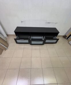The television unit shown in the picture is a modern black TV stand with three drawers featuring opaque glass fronts and open shelves for appliances. - Image 8