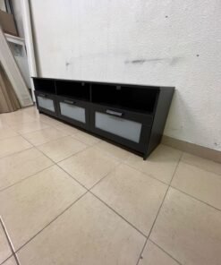 The television unit shown in the picture is a modern black TV stand with three drawers featuring opaque glass fronts and open shelves for appliances. - Image 9