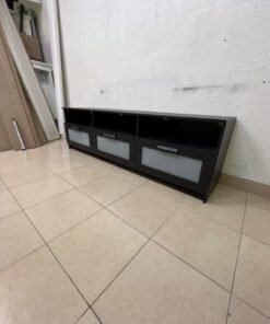 The television unit shown in the picture is a modern black TV stand with three drawers featuring opaque glass fronts and open shelves for appliances. - Image 10
