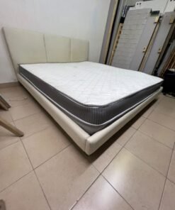 Double bed with a light beige upholstered design, featuring a split headboard and a white mattress with gray and black edges. - Image 2