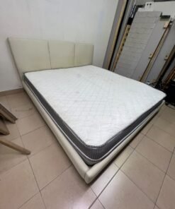 Double bed with a light beige upholstered design, featuring a split headboard and a white mattress with gray and black edges. - Image 3