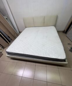 Double bed with a light beige upholstered design, featuring a split headboard and a white mattress with gray and black edges. - Image 4
