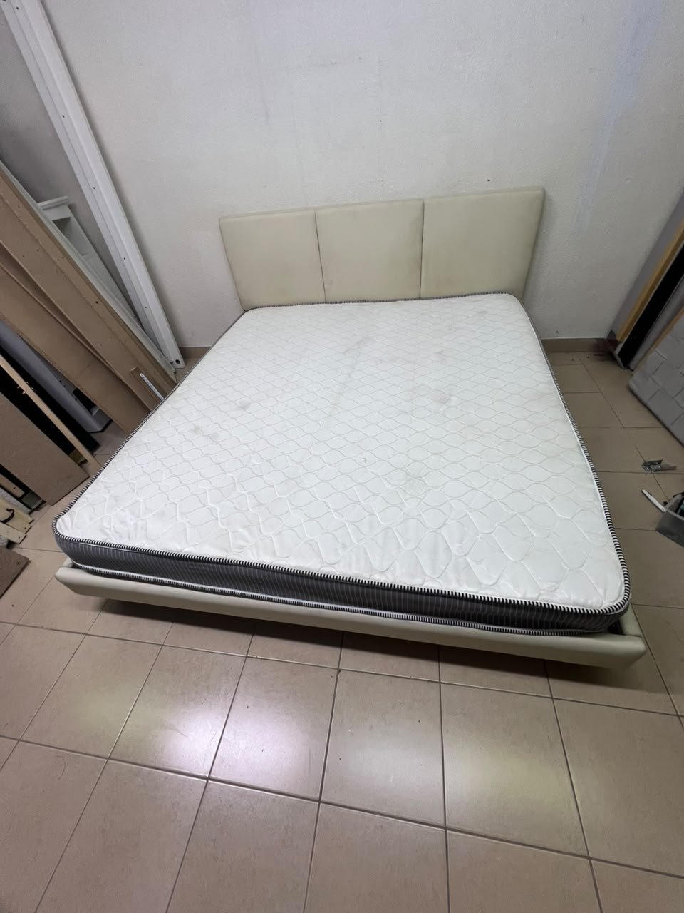Double bed with a light beige upholstered design, featuring a split headboard and a white mattress with gray and black edges. - Image 4