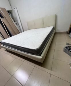 Double bed with a light beige upholstered design, featuring a split headboard and a white mattress with gray and black edges. - Image 5
