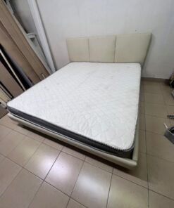 Double bed with a light beige upholstered design, featuring a split headboard and a white mattress with gray and black edges. - Image 9