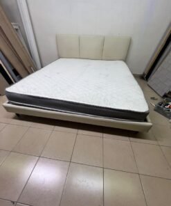 Double bed with a light beige upholstered design, featuring a split headboard and a white mattress with gray and black edges. - Image 8