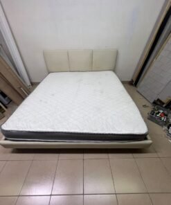 Double bed with a light beige upholstered design, featuring a split headboard and a white mattress with gray and black edges. - Image 7