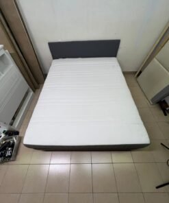 A gray upholstered bed frame with a white mattress and blanket, or a dark gray mattress on the side. - Image 4