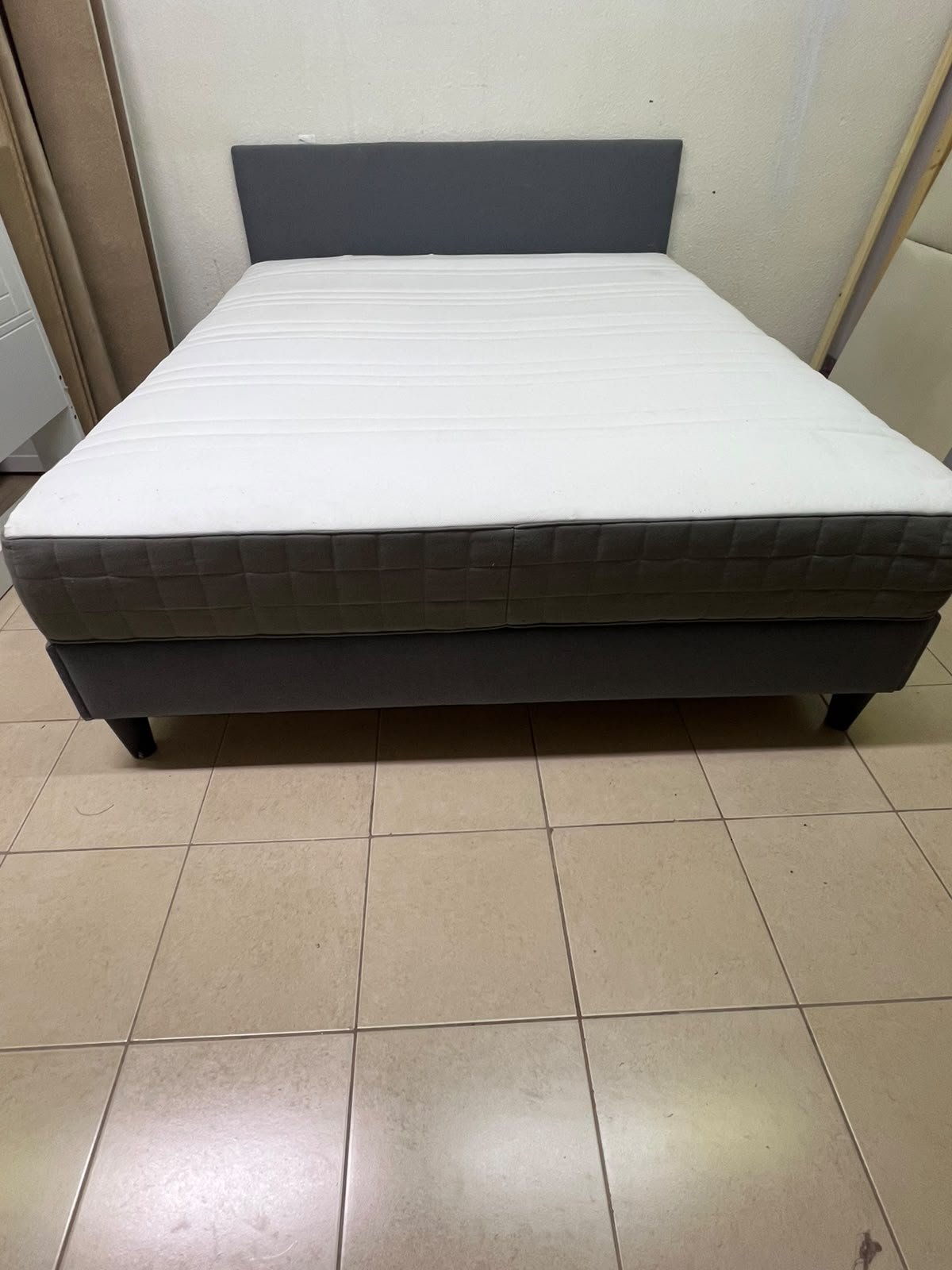 A gray upholstered bed frame with a white mattress and blanket, or a dark gray mattress on the side. - Image 5