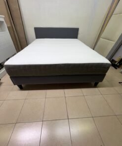 A gray upholstered bed frame with a white mattress and blanket, or a dark gray mattress on the side. - Image 6