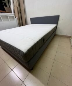 A gray upholstered bed frame with a white mattress and blanket, or a dark gray mattress on the side. - Image 7