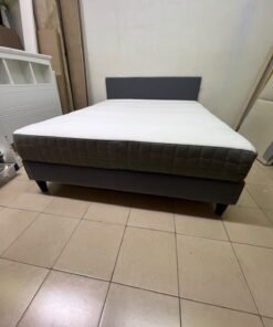 A gray upholstered bed frame with a white mattress and blanket, or a dark gray mattress on the side. - Image 9