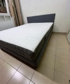 A gray upholstered bed frame with a white mattress and blanket, or a dark gray mattress on the side. - Image 10