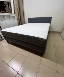 A gray upholstered bed frame with a white mattress and blanket, or a dark gray mattress on the side. - Image 13