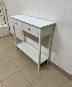 A modern white console table featuring two drawers with a striped front and small handles, as well as an open bottom shelf.