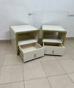The image shows two modern bedside tables in a creamy white finish, featuring gold frames and details, as well as ribbed drawer fronts (from Home Centre). - Image 5