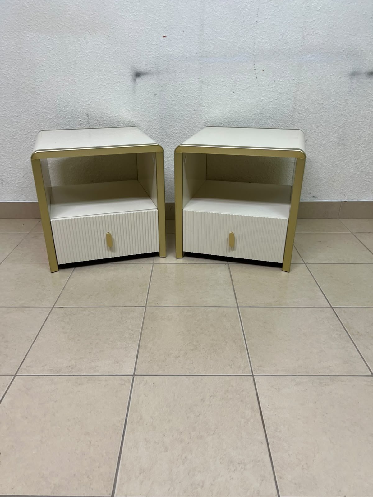 The image shows two modern bedside tables in a creamy white finish, featuring gold frames and details, as well as ribbed drawer fronts (from Home Centre). - Image 7