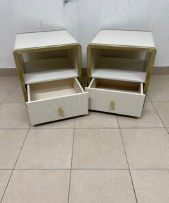 The image shows two modern bedside tables in a creamy white finish, featuring gold frames and details, as well as ribbed drawer fronts (from Home Centre). - Image 8