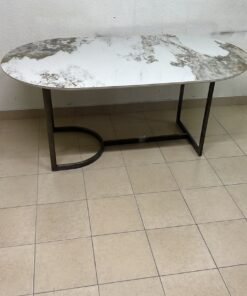 An oval dining table with a marble-patterned ceramic top, surrounded by four chairs upholstered in light beige fabric and featuring button-tufted backrests. - Image 7